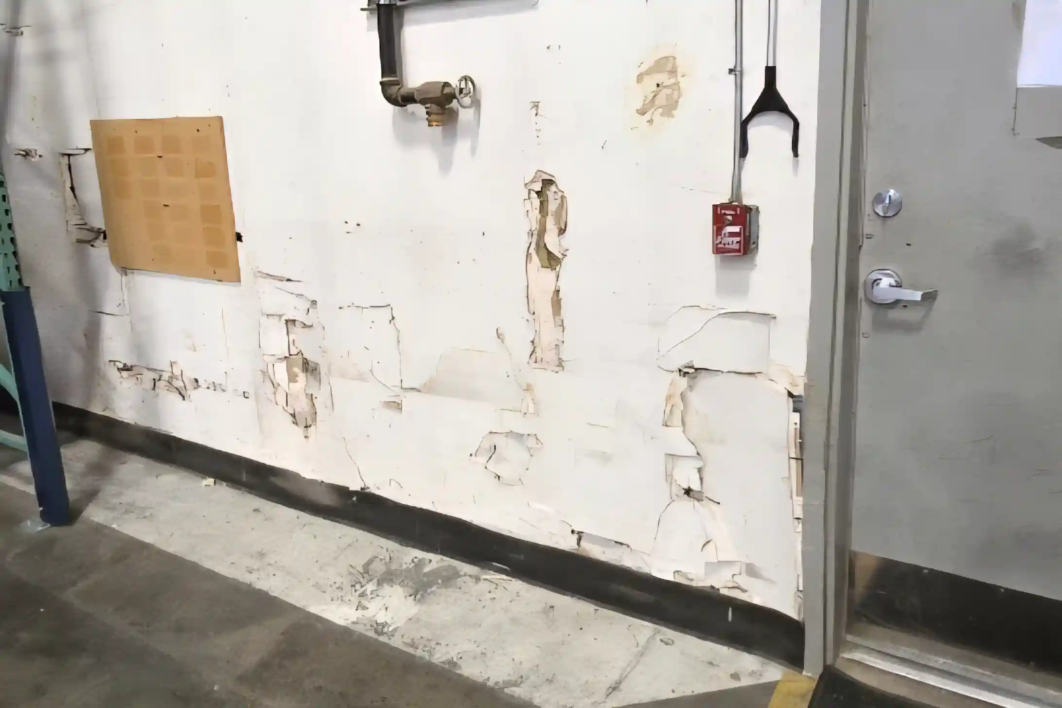 Multi-hole drywall repair before in Murray Utah